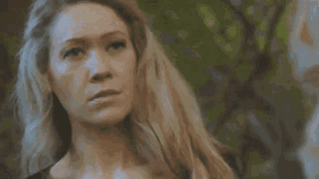 a close up of a woman 's face with the words oh okay behind her