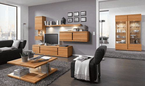 a living room with a couch a chair a television and a coffee table