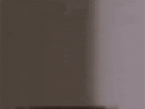 a close up of a man 's face with glasses looking out of a doorway .