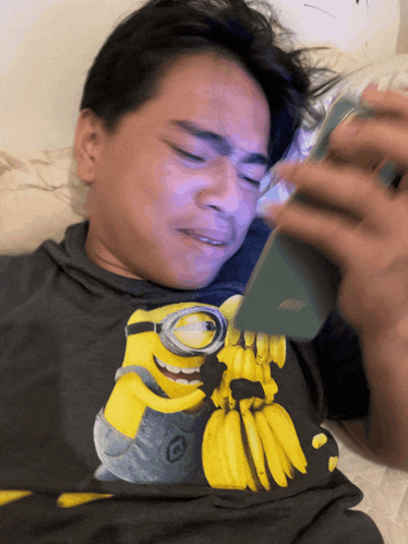 a man wearing a shirt with a picture of a minion holding bananas