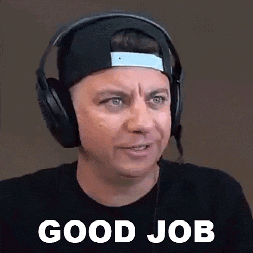 a man wearing headphones and a hat is giving a good job .