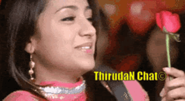 a woman in a pink dress is holding a red rose with the words thirudan chat written on the bottom