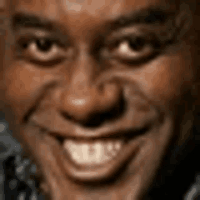a close up of a man 's face with a smile on it .