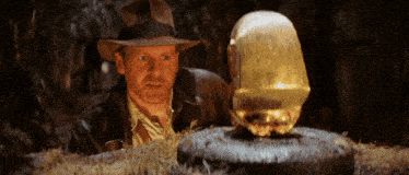a man in a hat is standing next to a glowing object