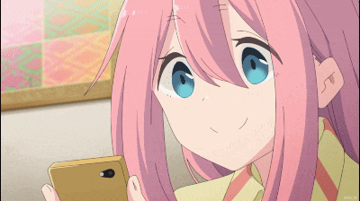 a girl with pink hair and blue eyes is holding a cellphone