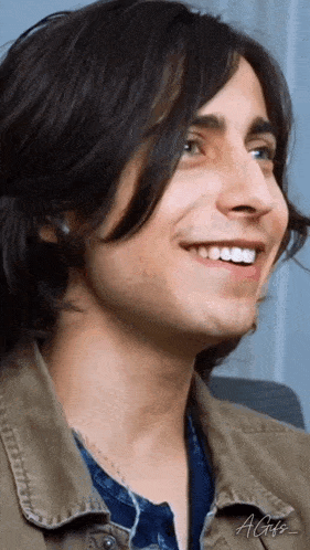 a close up of a man 's face with a smile on his face