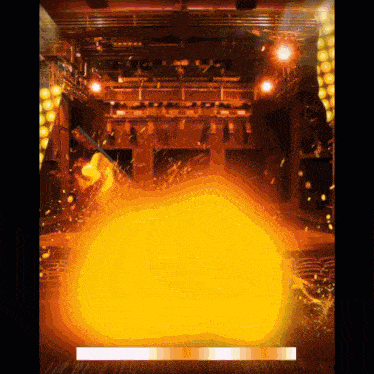 an animated image of a stage with a large fireball in the center