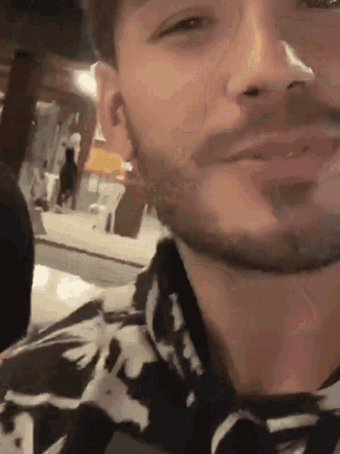 a close up of a man 's face with a beard .