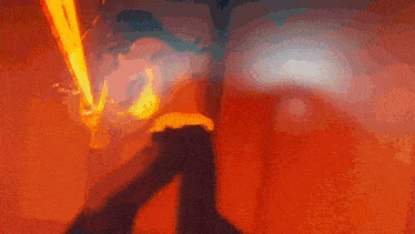 a blurry image of a person holding a sword in a dark room