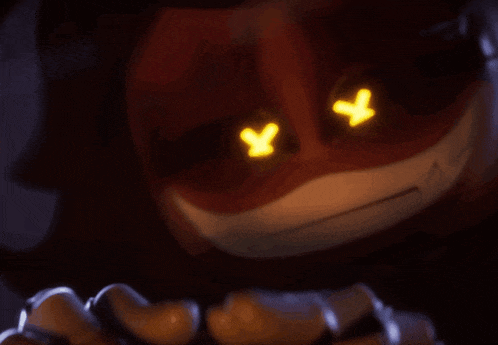 a close up of a pumpkin with glowing eyes and a x on them