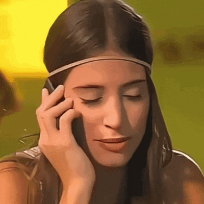 a woman wearing a headband is talking on her cell phone