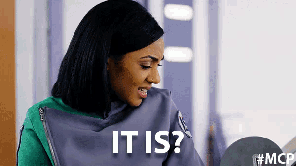 a woman in a green jacket is smiling and asking , `` it is ? '' .
