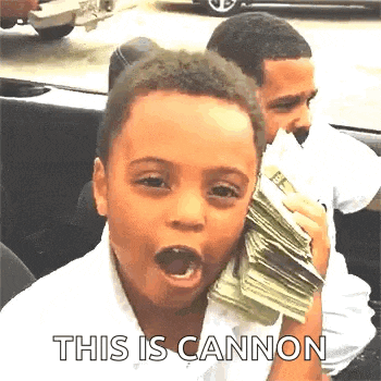a young boy is sitting in a car holding a stack of money .