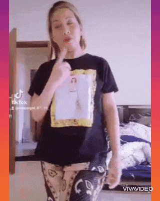 a woman wearing a black t-shirt with a picture on it