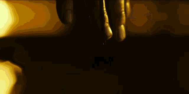 a close up of a person 's hand holding a fork in the dark .