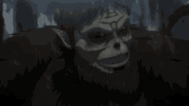 a close up of a monster with a beard and a skull on his face