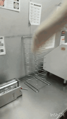 a person throws a piece of dough into a rack that says inshot on it