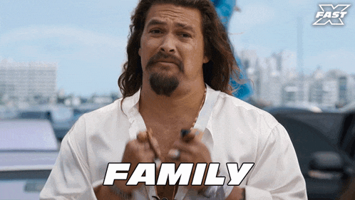 a man with long hair and a beard has the word family on his shirt