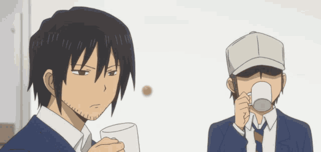 a man drinking from a cup while another man looks on
