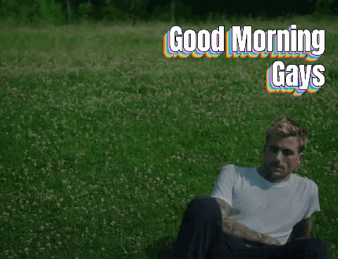 a man sitting in a field with the words good morning gays
