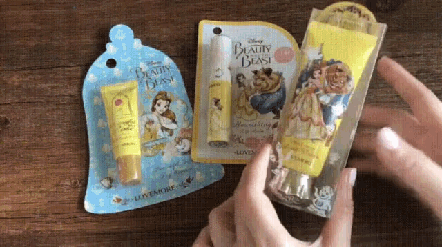 a person holding a beauty and the beast lip balm