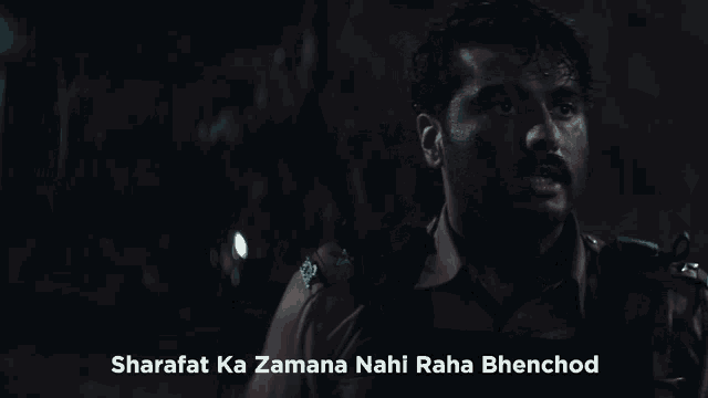 a man in a dark room with the words sharafat ka zamana nahi raha bhenchod