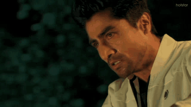 a close up of a man 's face with the word hotstar on the bottom right