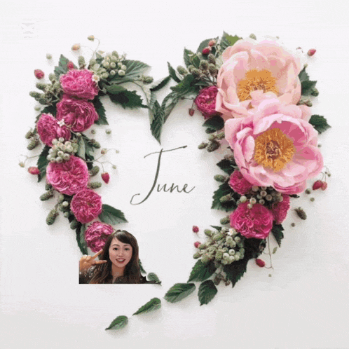 a heart made of pink flowers and leaves with the word june on it