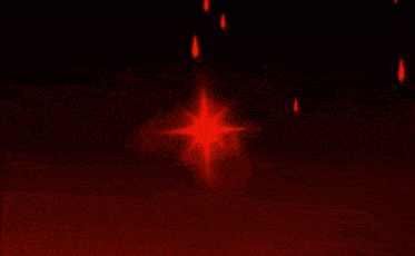 a red explosion on a black background with a few pieces flying out of it