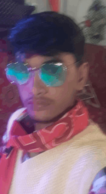 a blurry picture of a man wearing sunglasses and a red scarf
