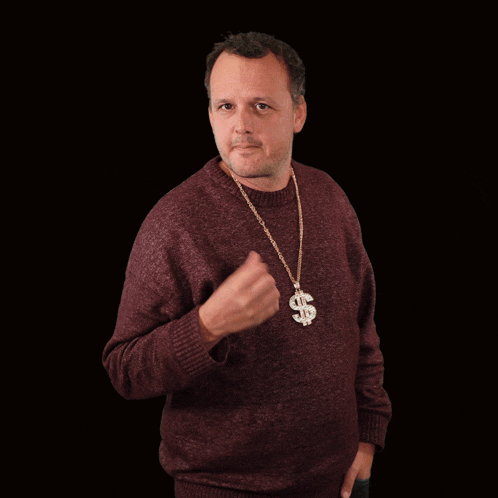 a man wearing a chain with a dollar sign on it