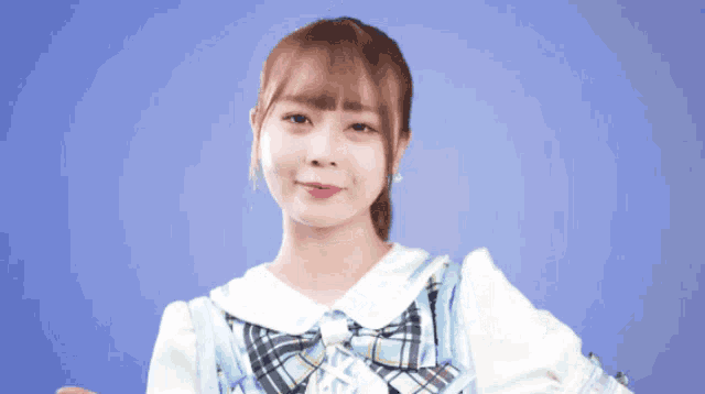 a girl wearing a plaid dress and a bow tie
