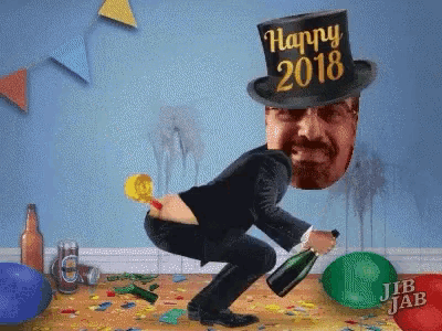 a man wearing a top hat that says happy 2018 is squatting down