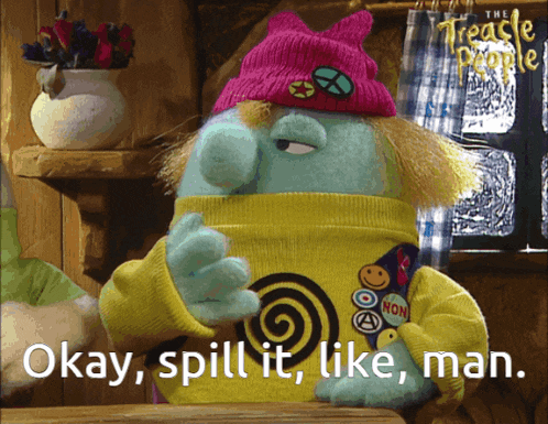 a cartoon character with a pink hat and a yellow sweater says okay spill it like man