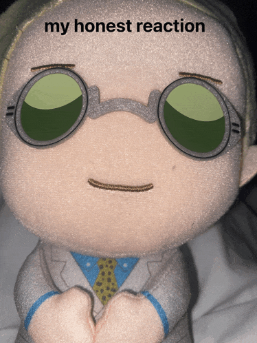 a stuffed toy with glasses and the words my honest reaction on it
