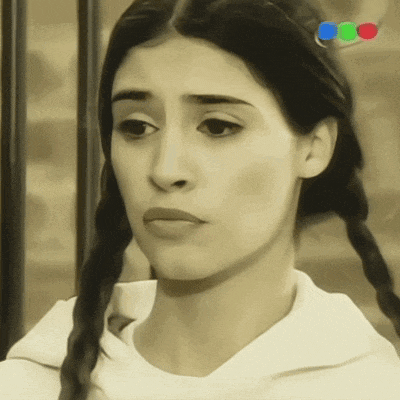 a woman 's face is shown in a black and white photo with a red blue and green border