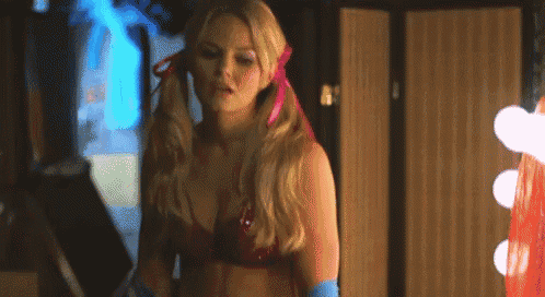 a woman in a red bra and blue gloves is standing in front of a mirror