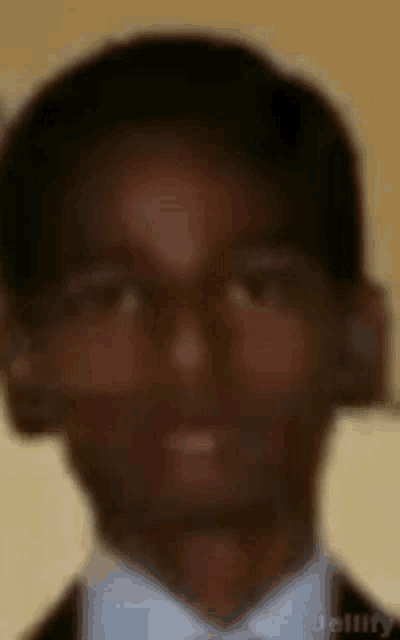 a blurry picture of a man in a suit and tie .