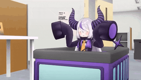 a cartoon character with horns is sitting in a box