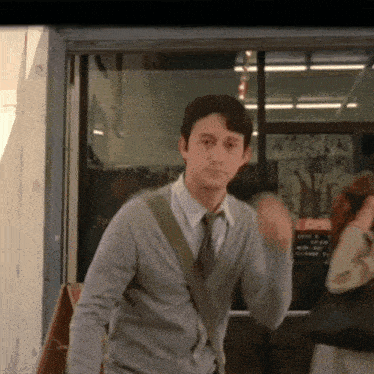a man standing in front of a store with a sign that says ' o'neill ' on it