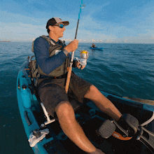 a man in a kayak with a fishing rod
