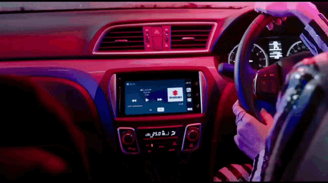 a person is driving a car with a suzuki radio