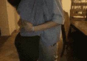 a couple is hugging each other in a living room .