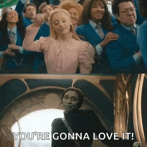 a woman in a pink dress is standing in front of a group of people and says `` you 're gonna love it '' .