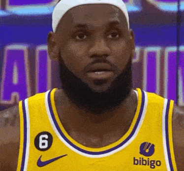 a basketball player with a beard is wearing a yellow jersey with a bibigo logo on it .