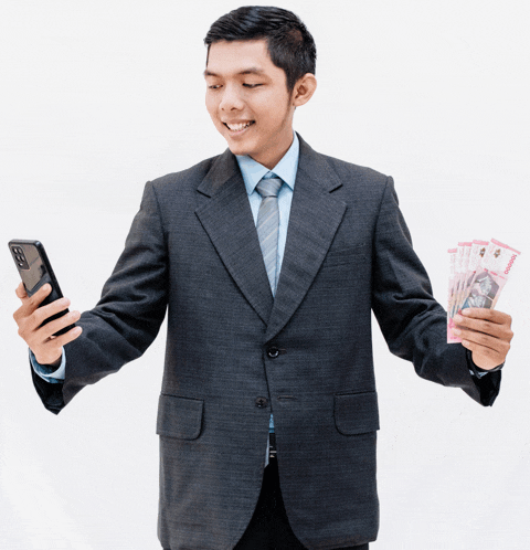 a man in a suit holds a stack of money and a cell phone