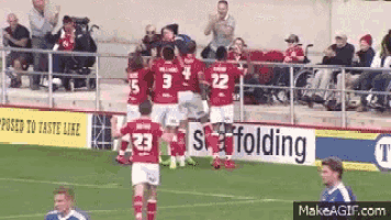 a group of soccer players on a field with a sign that says scaffolding