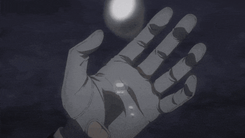 a person 's hand is reaching out towards the moon