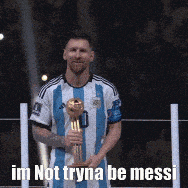 a man holding a trophy that says im not tryna be messi on it