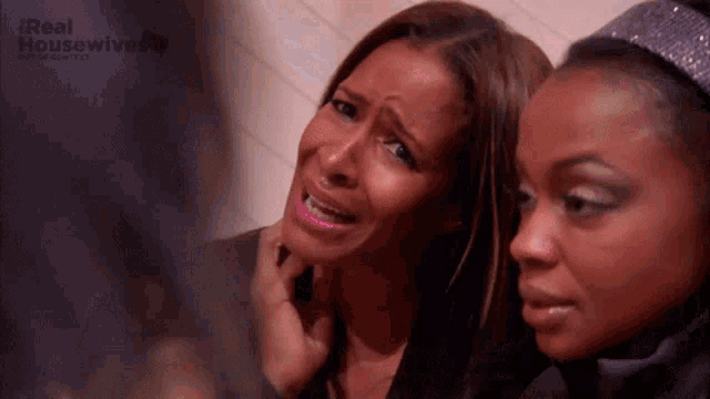 a woman is crying while another woman looks on .
